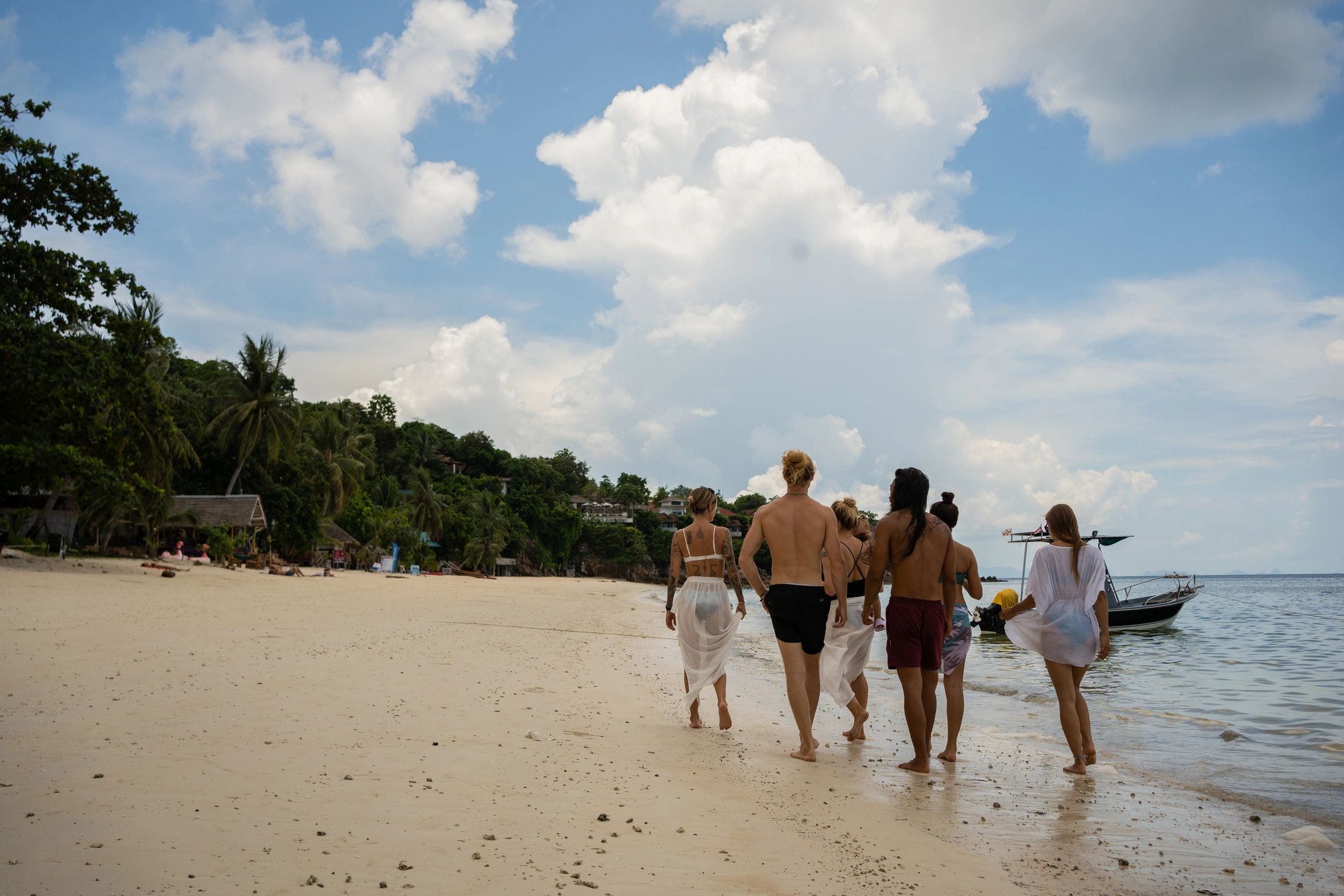 Group walking along a beach during a break
