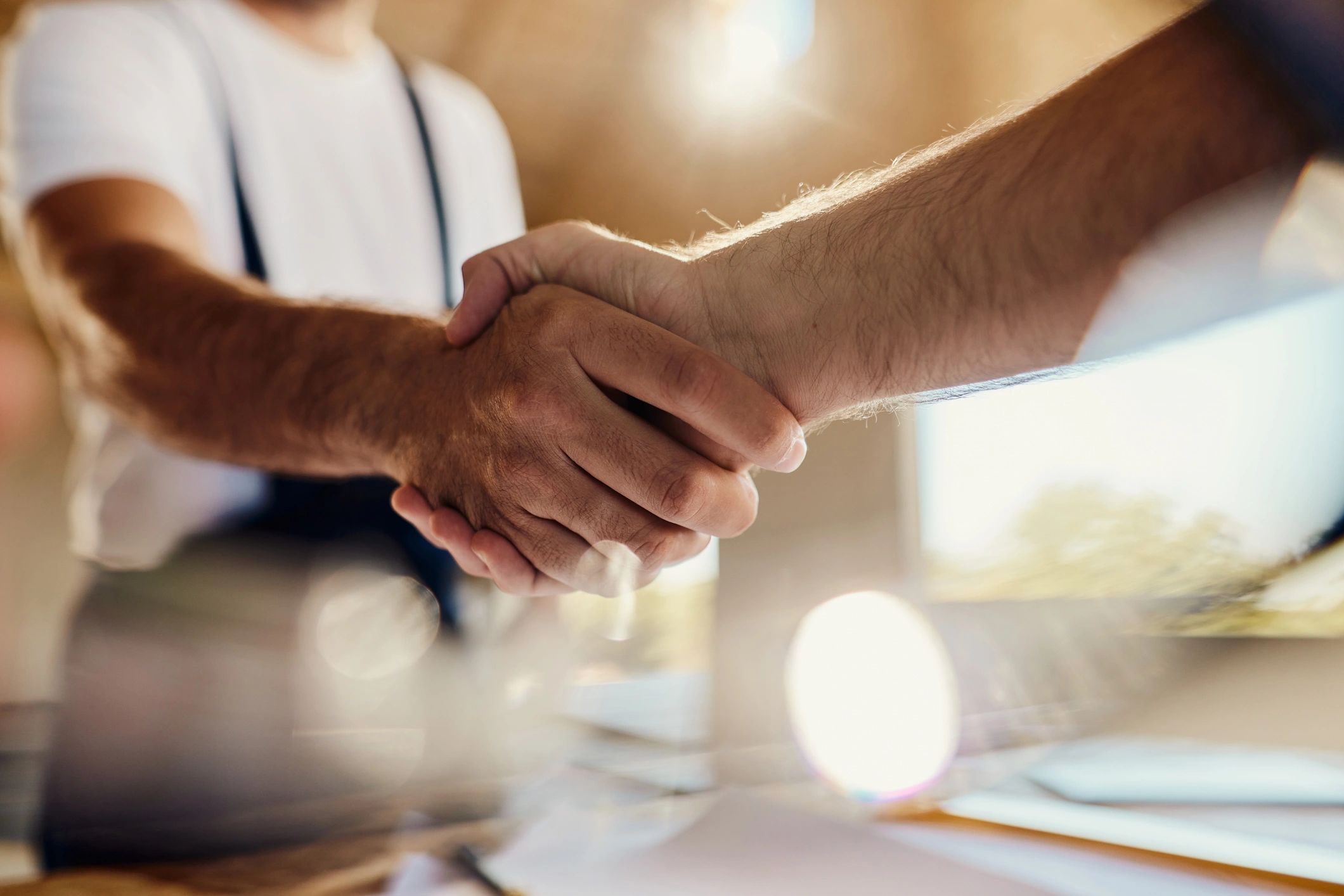 Two people shaking hands to symbolize volunteer commitment and support