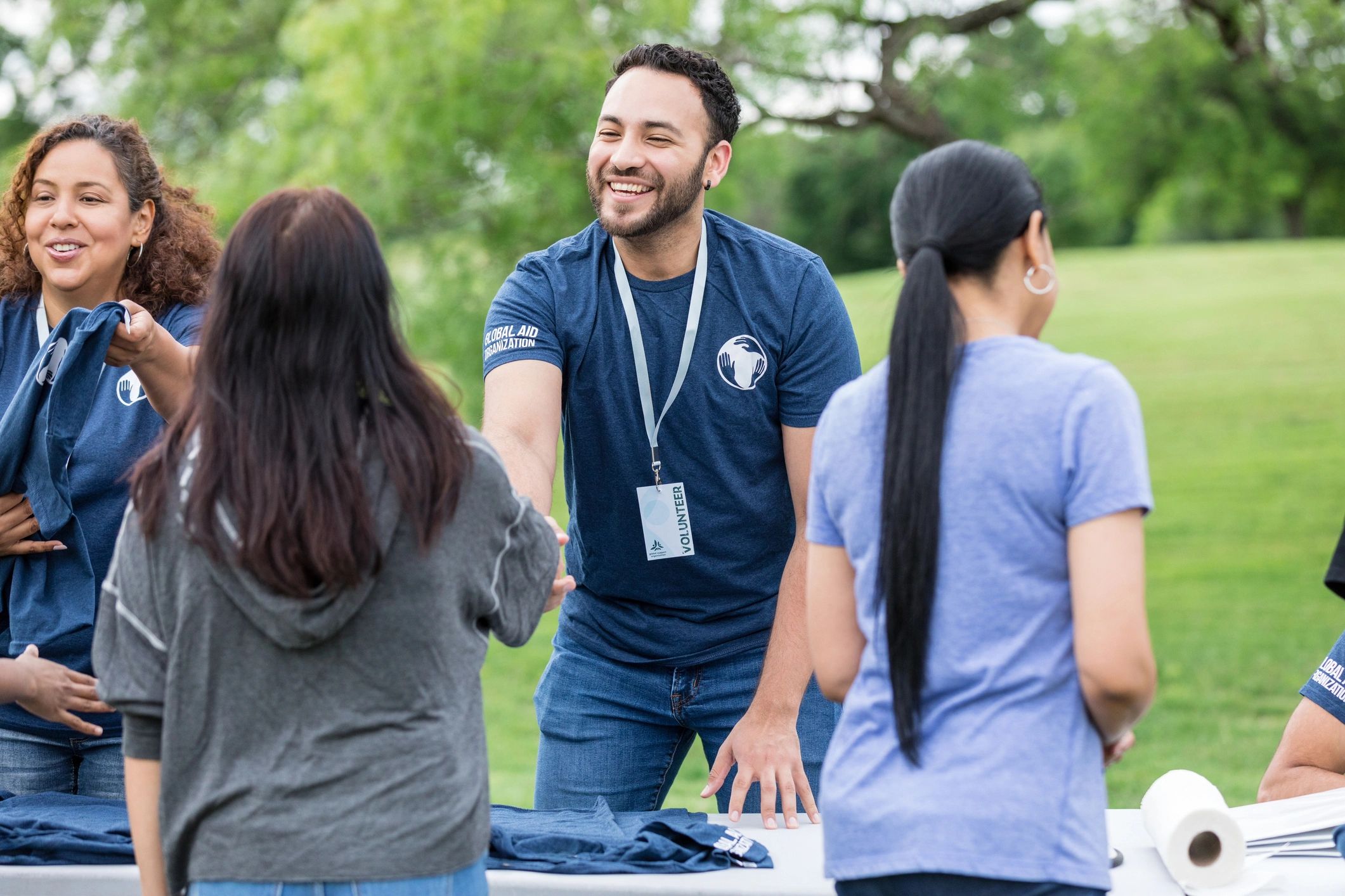 Volunteer greeting someone with a handshake
