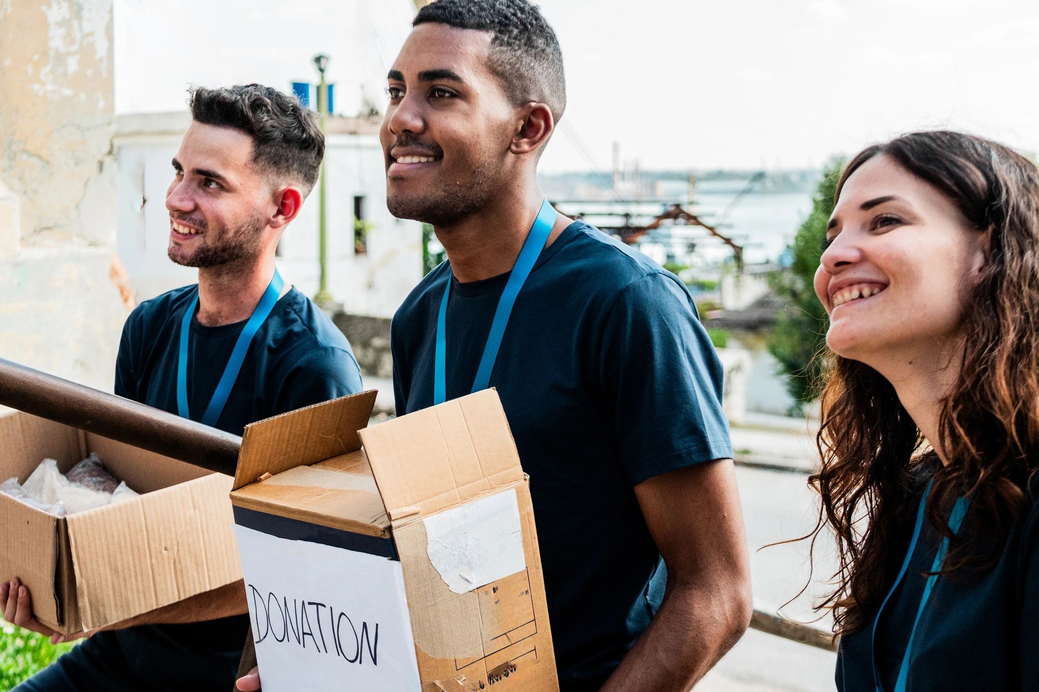 Volunteers carrying donation boxes outdoors