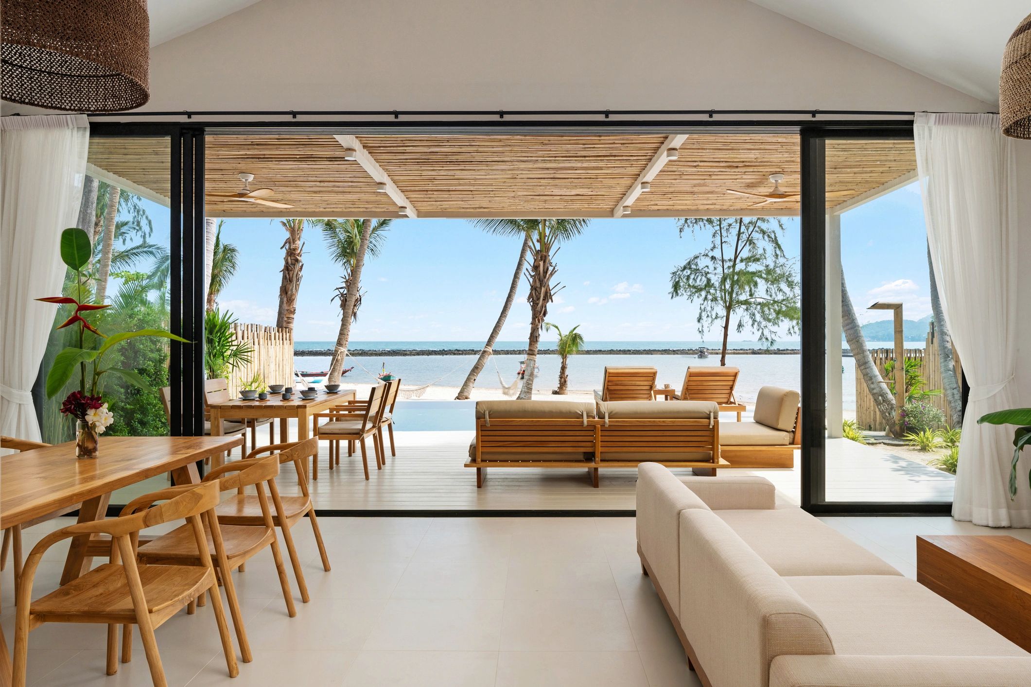 Open indoor-outdoor lounge and dining area overlooking the ocean, representing club facilities