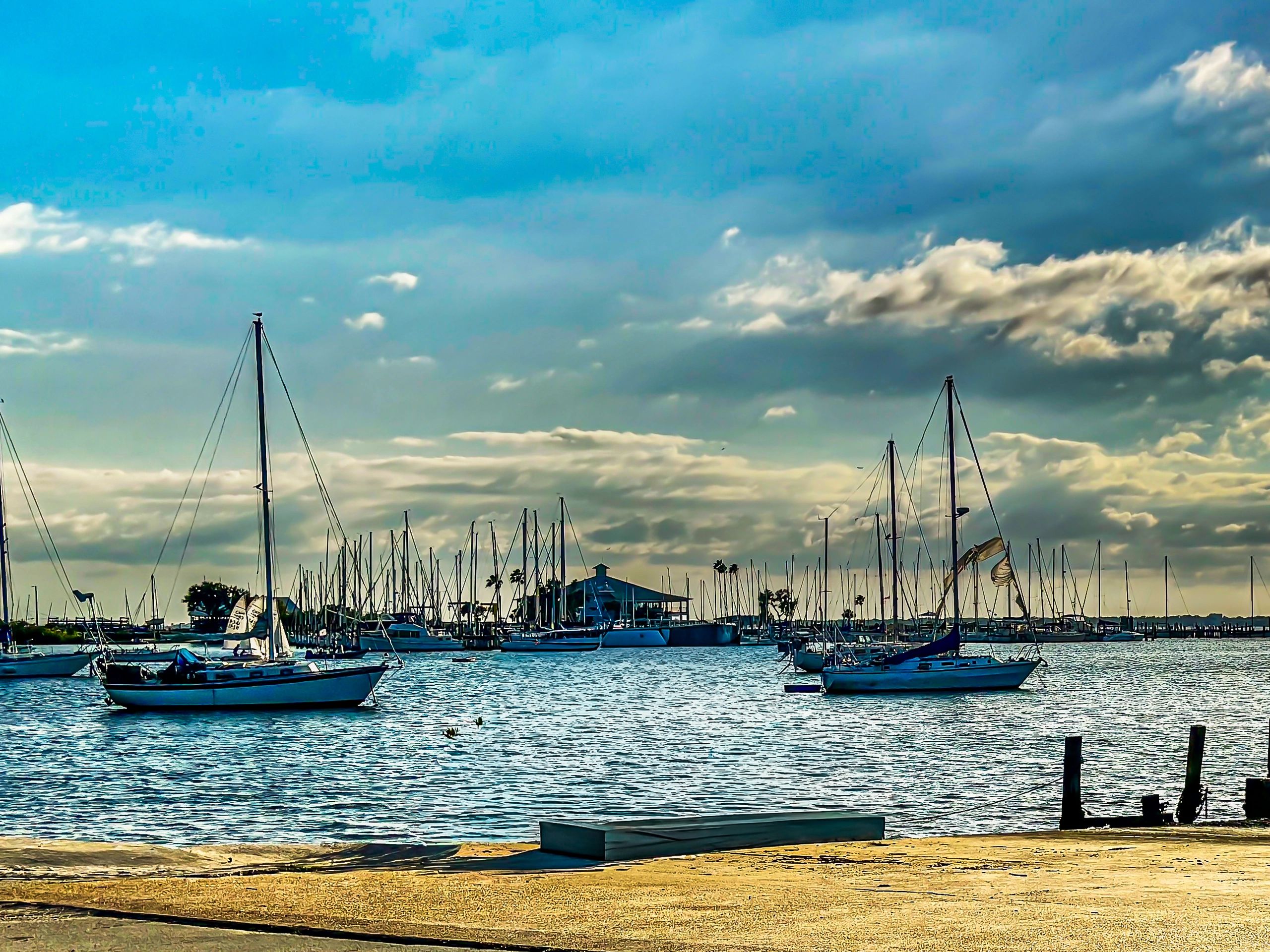 Sailboats in a marina at sunset, symbolizing rest and connection after time at sea